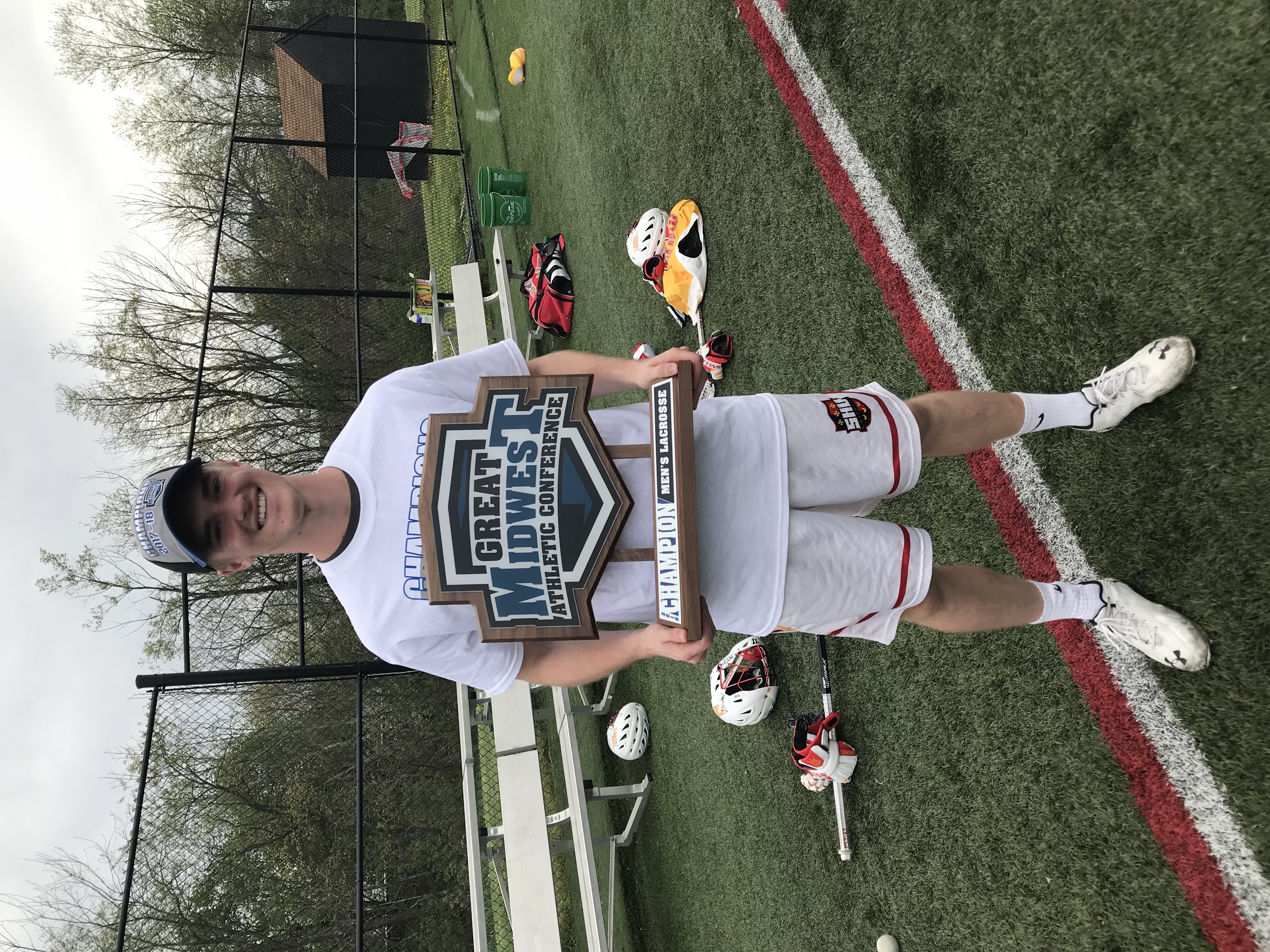Alec holding the GMAC championship trophy